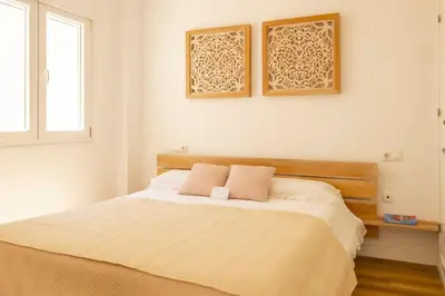 a bedroom with a bed with two pillows on it at Cadizz-Ático El Falla con terraza de 40m2 in Cádiz