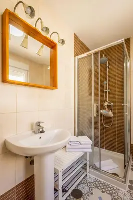 a bathroom with a sink and a shower at Cadizz-Ático El Falla con terraza de 40m2 in Cádiz