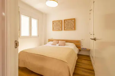 a bedroom with a bed and a window at Cadizz-Ático El Falla con terraza de 40m2 in Cádiz