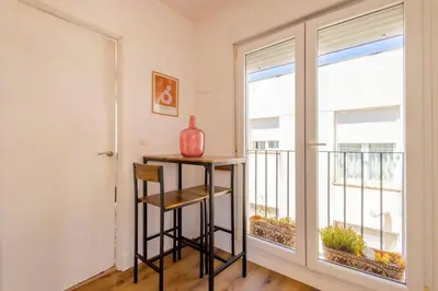 a room with a table and a window with a vase on it at Cadizz-Ático El Falla con terraza de 40m2 in Cádiz