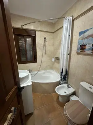 a bathroom with a tub and a toilet and a sink at El Levante in Chiclana de la Frontera