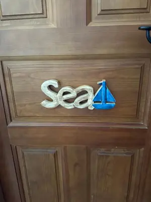 a wooden door with the word sea on it at El Levante in Chiclana de la Frontera