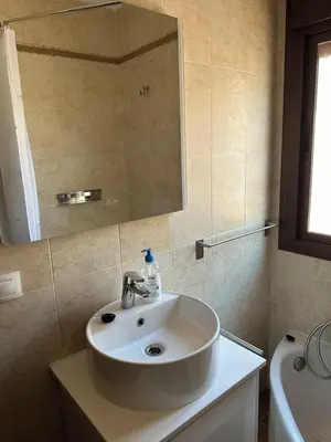 a bathroom with a white sink and a mirror at El Levante in Chiclana de la Frontera