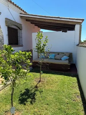 a garden with a bed in the back of a house at El Levante in Chiclana de la Frontera