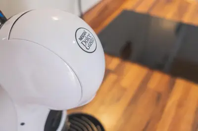 a white hair dryer sitting on top of a wooden floor at Geminis in Rota