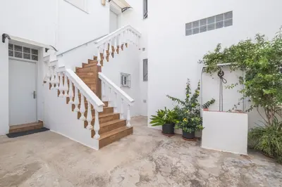 a staircase in a white house with plants at Geminis in Rota