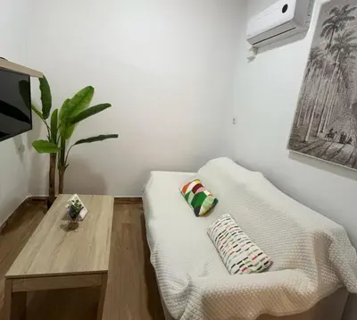 three towels sitting on a bed in a bedroom at Apartamento Caleta Beach in Cádiz