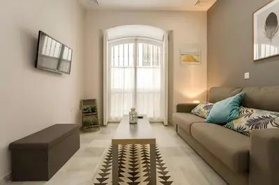 a living room with a couch and a coffee table at Loft El Capricho Grupo Ac Gestion in Cádiz