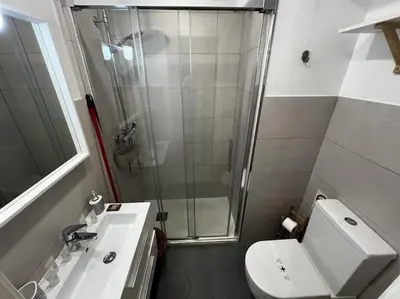 a bathroom with a shower and a toilet and a sink at Loft El Capricho Grupo Ac Gestion in Cádiz