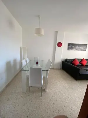 a living room with a glass table and a couch at Apartamento en Jerez de la Frontera in Jerez de la Frontera