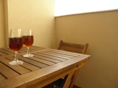 two glasses of wine sitting on a wooden table at Apartamento en Jerez de la Frontera in Jerez de la Frontera