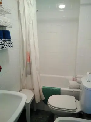 a bathroom with a toilet and a sink and a tub at Piso Con Hermosas Vistas Al Mar in El Puerto de Santa María