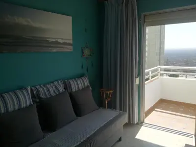 a bedroom with a bed and a large window at Piso Con Hermosas Vistas Al Mar in El Puerto de Santa María