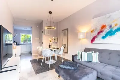 a living room with a couch and a table at Penthouse Sol y Mar in Poblado de Sancti Petri