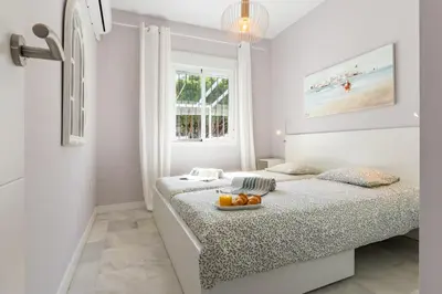 a bedroom with a bed with a tray of fruit on it at Penthouse Sol y Mar in Poblado de Sancti Petri