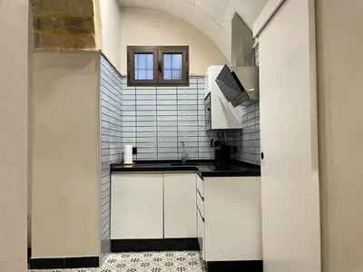 a kitchen with white cabinets and a sink at Apartamento Plaza del Cabildo II - Sanlúcar Centro in Sanlúcar de Barrameda