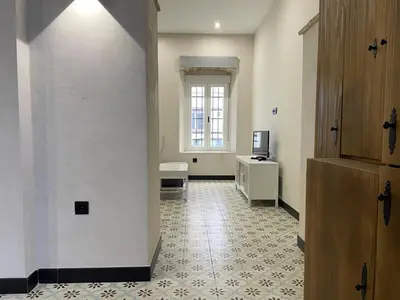 an empty hallway with a room with a window at Apartamento Plaza del Cabildo II - Sanlúcar Centro in Sanlúcar de Barrameda
