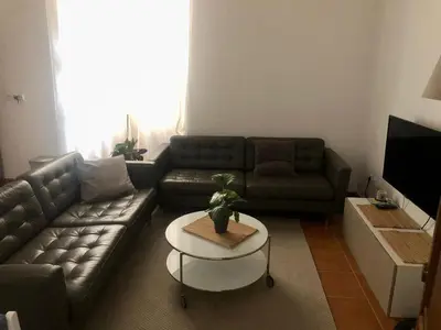 a living room with a couch and a table at Apartamento San Bartolomé in El Puerto de Santa María