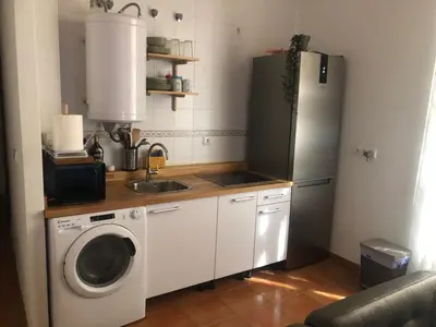 a kitchen with a refrigerator and a washing machine at Apartamento San Bartolomé in El Puerto de Santa María