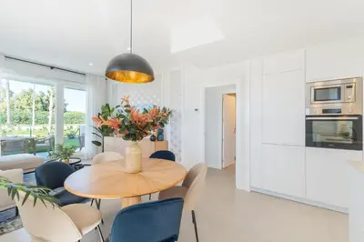 a kitchen and dining room with a table and chairs at Oasis playa costa Ballena in Costa Ballena