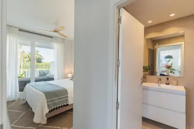a bedroom with a bed and a sink and a window at Oasis playa costa Ballena in Costa Ballena