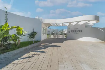 a view of the entrance to a white building at Oasis playa costa Ballena in Costa Ballena