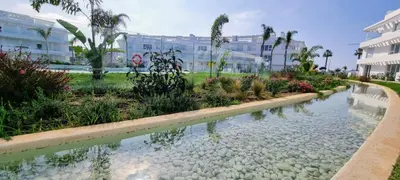 a pool of water in front of a building at Oasis playa costa Ballena in Costa Ballena