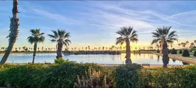 a pool of water with palm trees in a park at Oasis playa costa Ballena in Costa Ballena