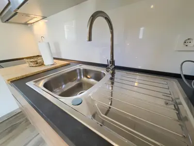 a flat screen tv on a wall above a sink at Villa Pinar del Novo in Chiclana de la Frontera