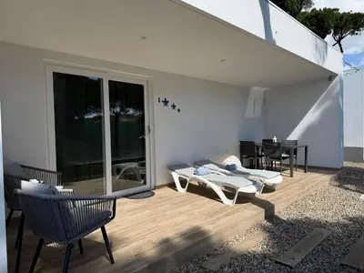 a backyard with a swimming pool and a tree at Villa Pinar del Novo in Chiclana de la Frontera