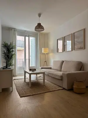 a living room with a couch and a table at Apartamentos Banda Playa in Sanlúcar de Barrameda