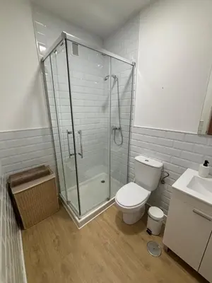 a bathroom with a shower and a toilet and a sink at Apartamentos Banda Playa in Sanlúcar de Barrameda