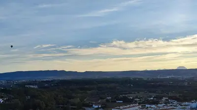 a kite flying in the sky over a city at El mirador de Beatriz in Arcos de la Frontera