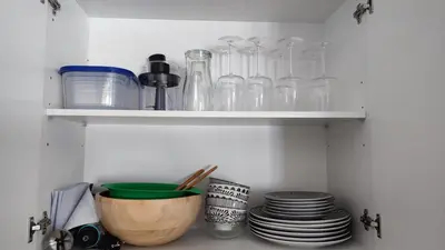 a shelf with glass bottles and plates on it at El mirador de Beatriz in Arcos de la Frontera