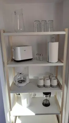 a kitchen shelf with various kitchen items on it at El mirador de Beatriz in Arcos de la Frontera