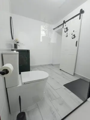 a white bathroom with a toilet and a shower at Casa Encarnita in Arcos de la Frontera