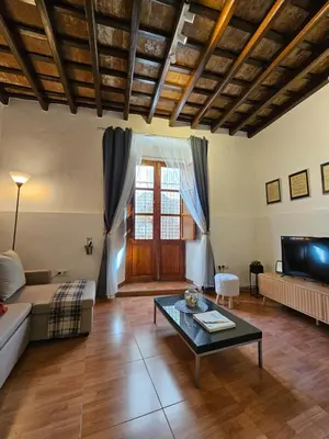 a living room with a couch and a coffee table at Sherryflat Naranjas 9 in Jerez de la Frontera