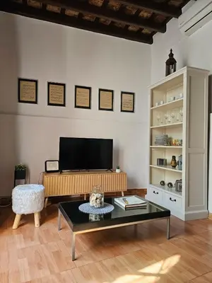a living room with a tv and a coffee table at Sherryflat Naranjas 9 in Jerez de la Frontera