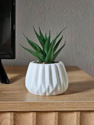 a plant in a white vase on a table at Sherryflat Naranjas 9 in Jerez de la Frontera