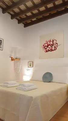 a white bed with two pillows on top of it at Sherryflat Naranjas 9 in Jerez de la Frontera