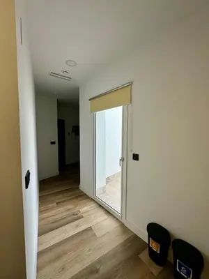 an empty room with a door with a window at Solera Suites in Jerez de la Frontera
