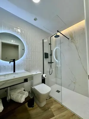 a bathroom with a toilet and a shower at Solera Suites in Jerez de la Frontera