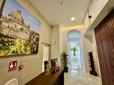 a bathroom with a large poster on the wall at Solera Suites in Jerez de la Frontera