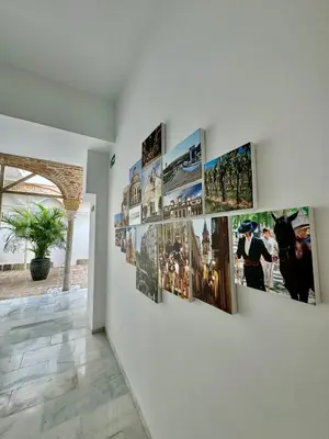 a group of pictures on a wall in a room at Solera Suites in Jerez de la Frontera
