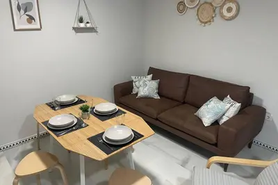a living room with a couch and a table at Apartamento La Barrosa Beach in Novo Sancti Petri