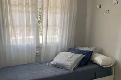 a bed with two pillows in a room with a window at Apartamento La Barrosa Beach in Novo Sancti Petri