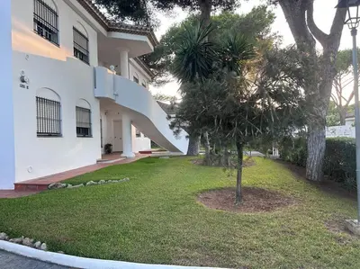 a house with a tree in front of it at Apartamento La Barrosa Beach in Novo Sancti Petri