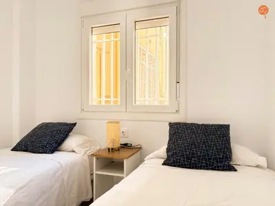 a bedroom with two beds and a window at La Palmera Grupo AC Gestion in Cádiz