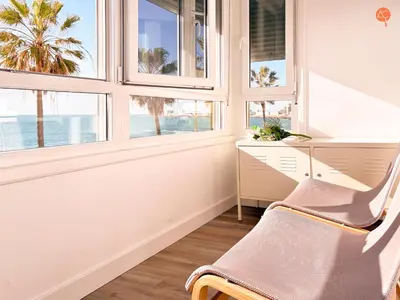 a room with windows and a desk and a chair at La Palmera Grupo AC Gestion in Cádiz