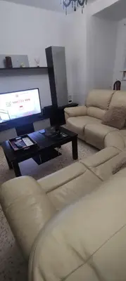 a living room with couches and a flat screen tv at Vivir es Increíble in San Fernando